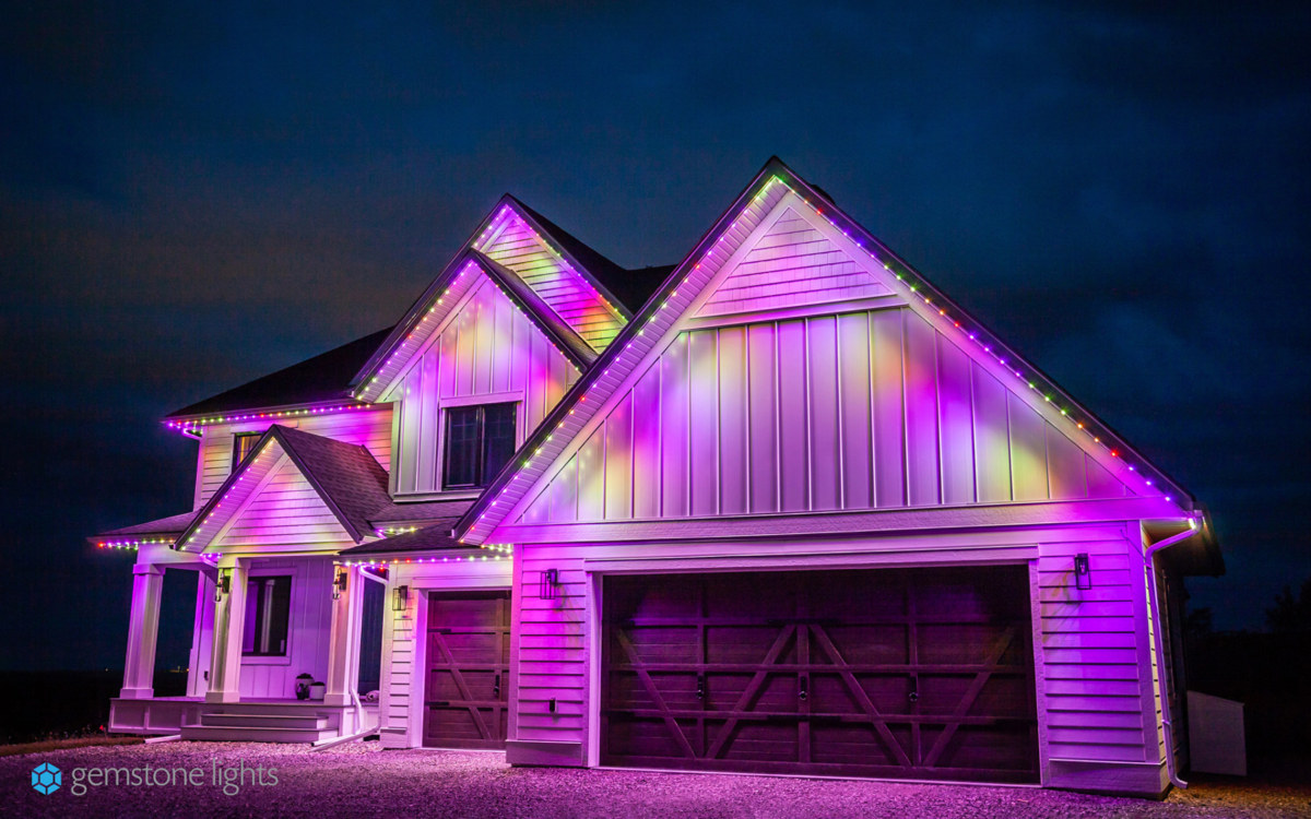 Front view of a house lit up with multicoloured lights.